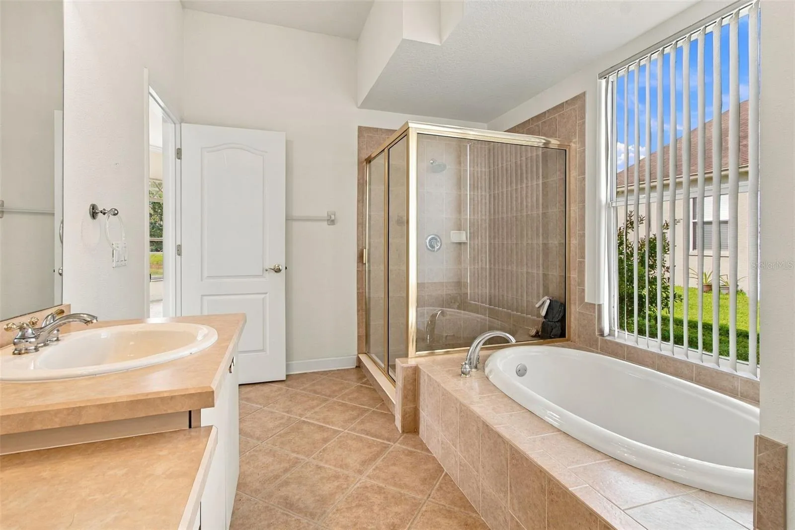 Your primary bathroom features a large window to allow plenty of sunlight into the room.