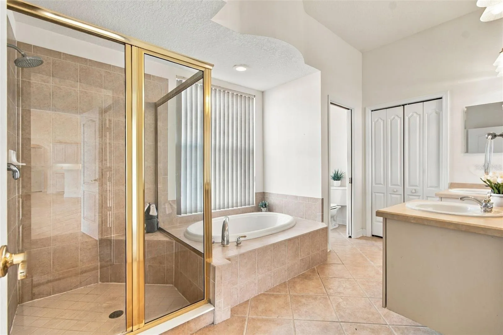 Your walk in shower features a shower rain head and a built in shower bench.