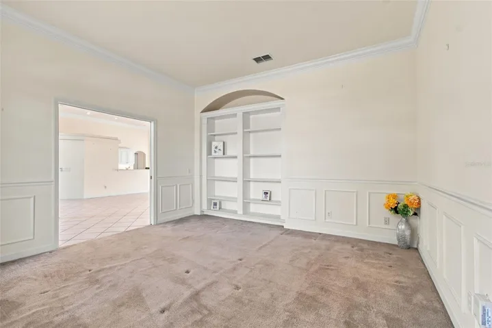Your flex room with double pocket doors, a custom build in shelf, custom wall paneling and window bench seat.