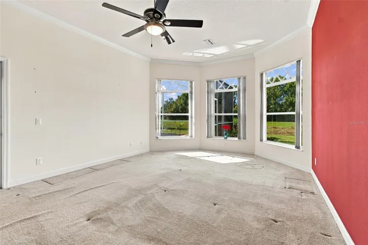 Oversized primary bedroom with three windows overlooking your heated spa, heated pool and conservation lot.