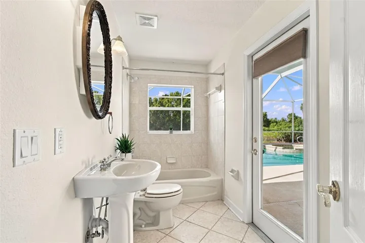 Secondary bathroom with easy access to the pool, spa and outdoor screened lanai.