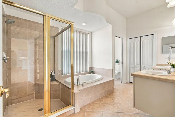 Your walk in shower features a shower rain head and a built in shower bench.