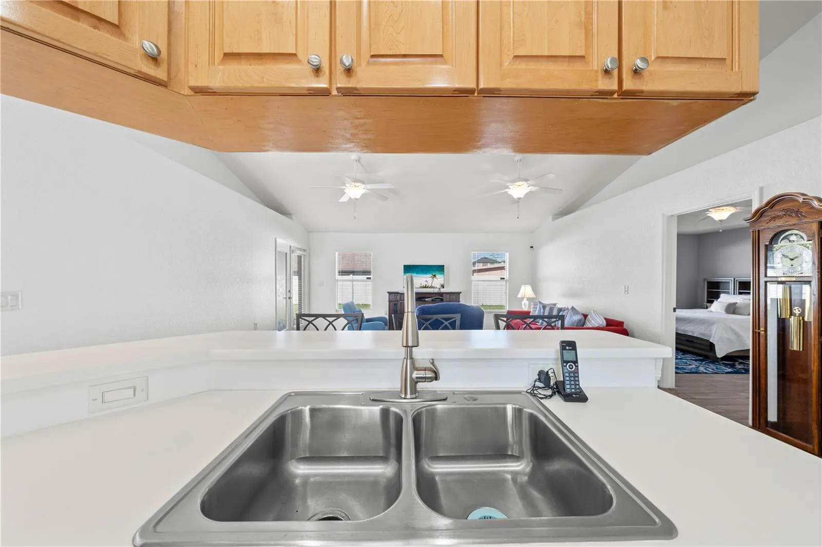 Kitchen sink, living room and primary bedroom to the right.