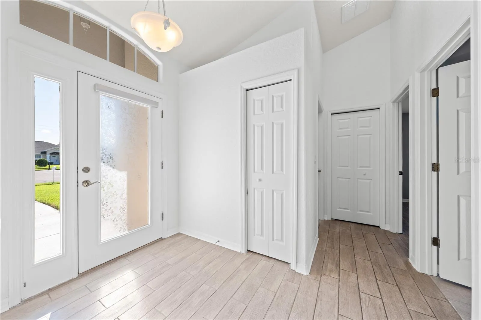 Foyer, Coat and vacuum closet, guest bathroom, bedroom 2 and 3 hallway.