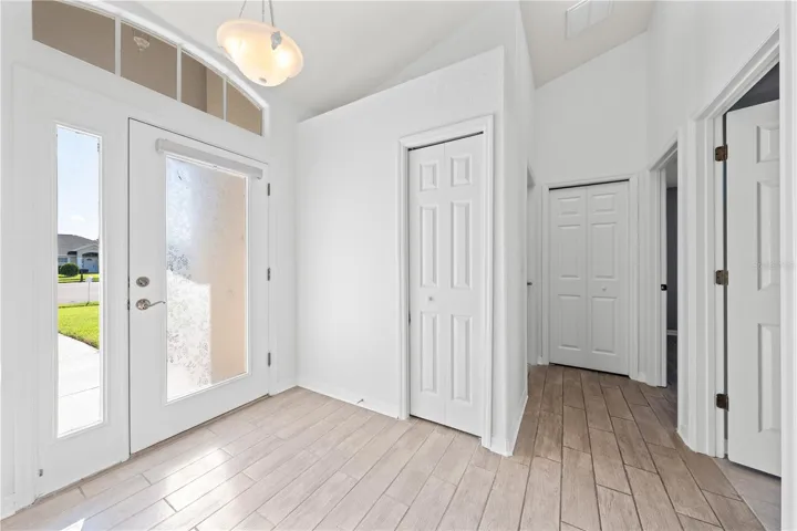 Foyer, Coat and vacuum closet, guest bathroom, bedroom 2 and 3 hallway.