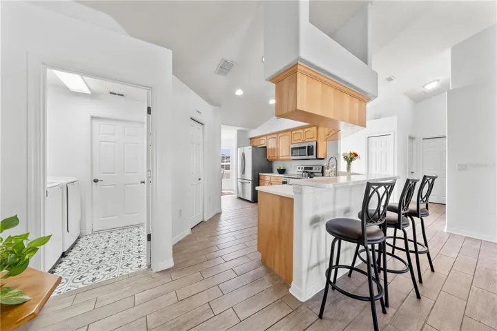 Kitchen and Laundry Room View, dining room on other side of kitchen
