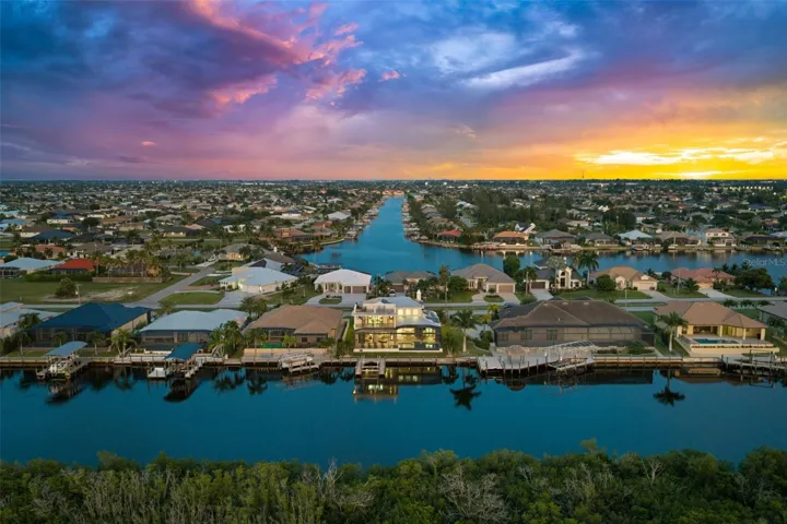 Aerial from the back, showing the water wonderland surrounding the home