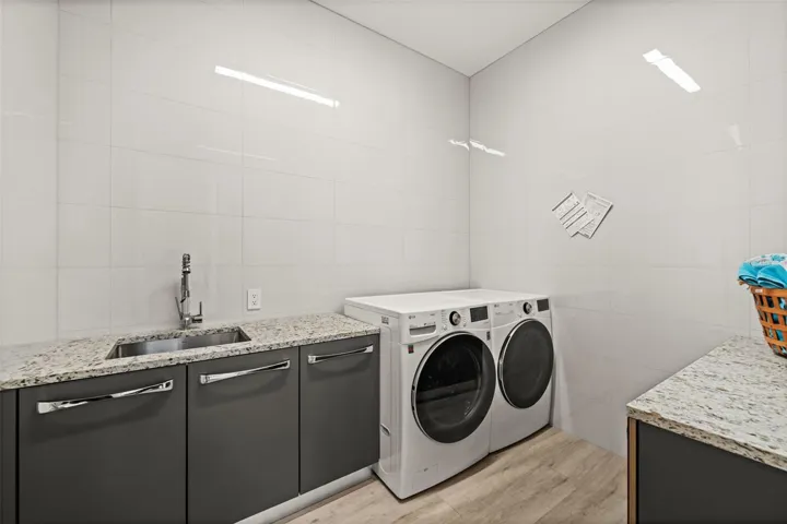 Well appointed Laundry Room with lots of cabinets