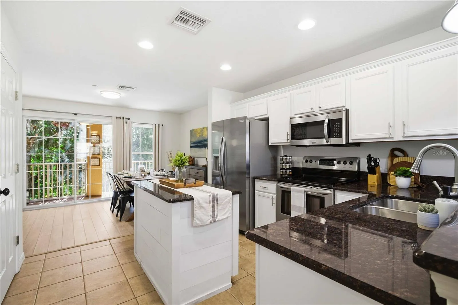 Light and bright, the kitchen stands at the heart of the main floor, separating the living room and dining room.
