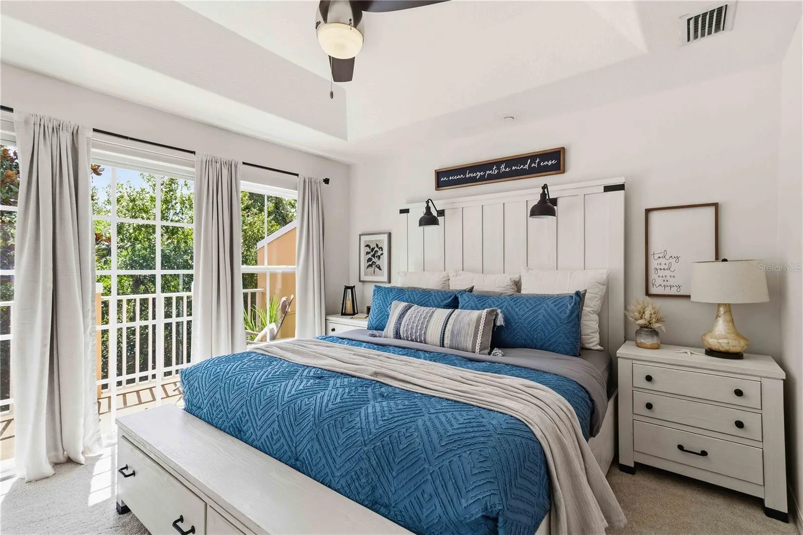 Nothing beats this cozy primary bedroom with it's own private balcony to enjoy the morning sun on your face!