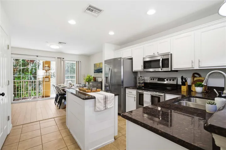 Light and bright, the kitchen stands at the heart of the main floor, separating the living room and dining room.