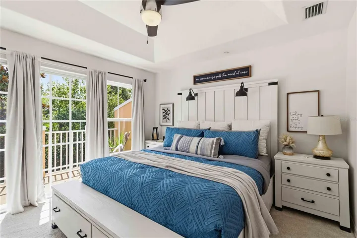 Nothing beats this cozy primary bedroom with it's own private balcony to enjoy the morning sun on your face!