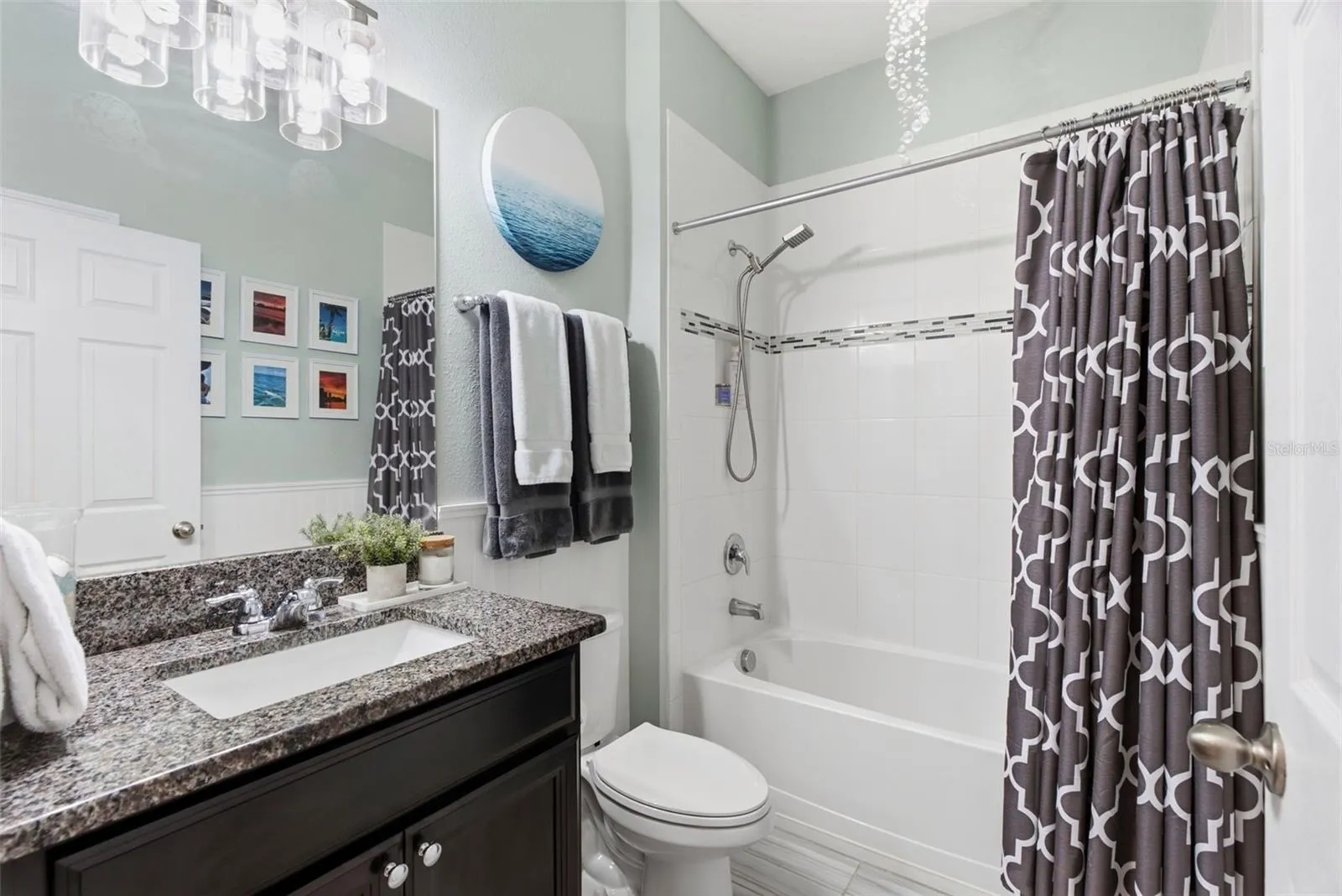 Well-appointed secondary bathroom featuring granite countertops