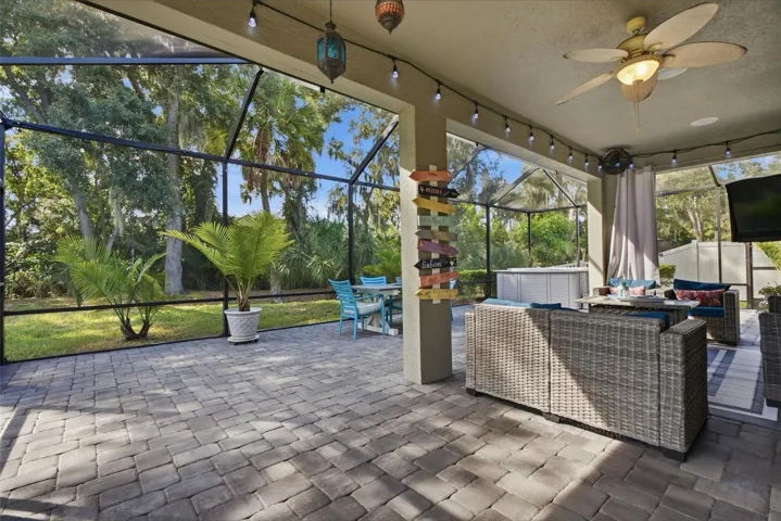 Expansive fully screened, paver-finished lanai extending your living space outdoors