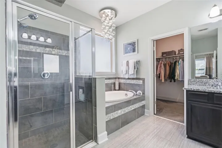 En-suite bathroom boasting a garden tub and frosted glass window.