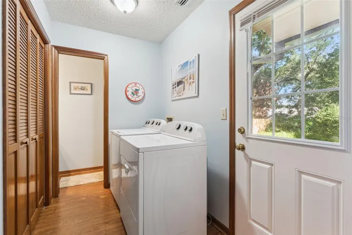Indoor laundry room with storage and convenient half bath