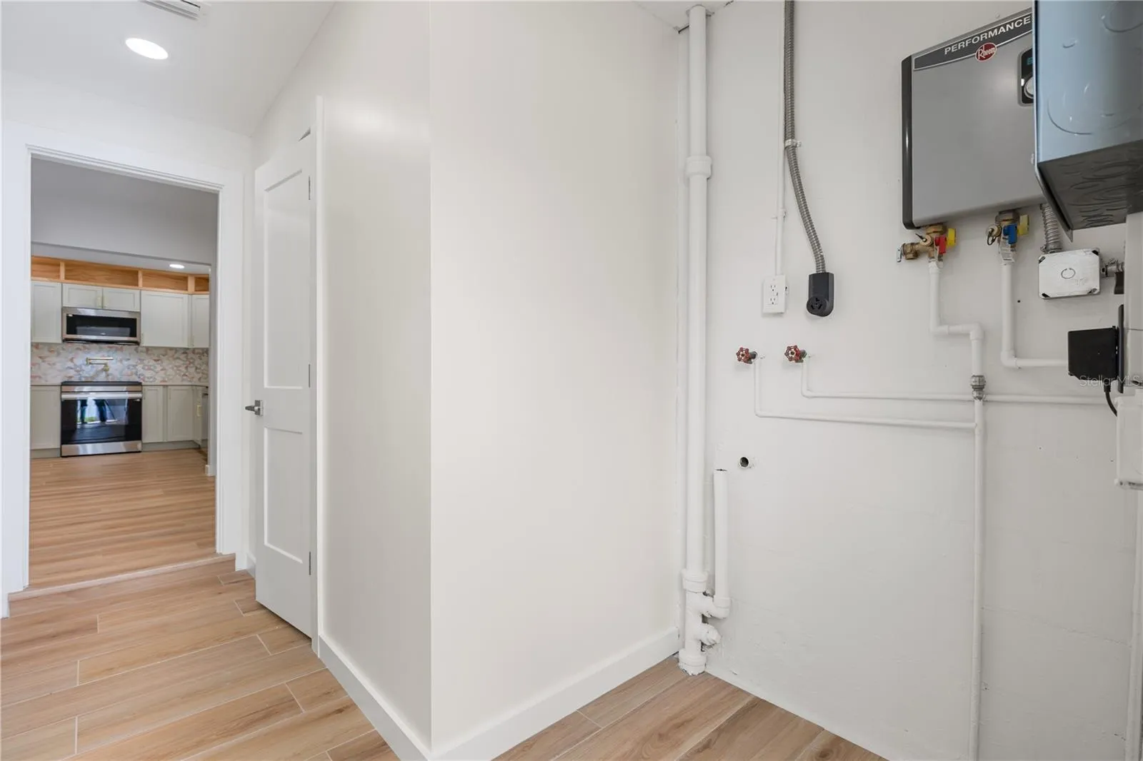 Interior laundry room features space for either a stackable set or all-in one system