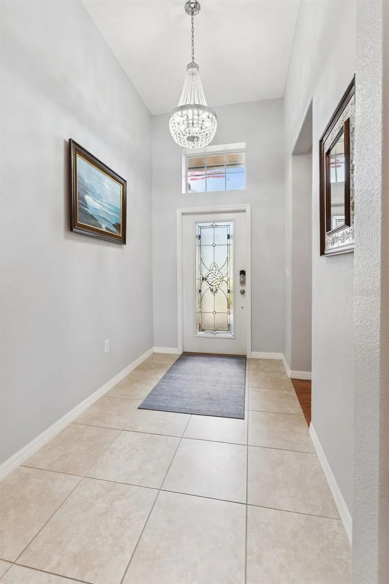 Custom Leaded Glass Front Door, Transom Window and Chandelier enhance the foyer