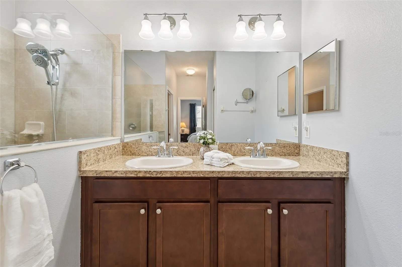 Primary Bath features a comfort height vanity with dual sinks, linen closet and a water closet