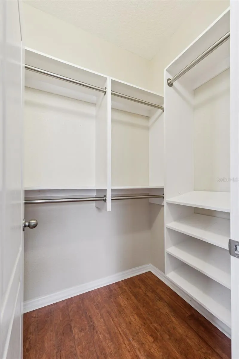Both closets feature deluxe closet organizer system