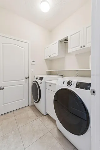 Laundry Room features cabinetry and upgraded Washer &amp; Dryer