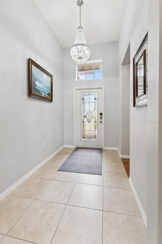 Custom Leaded Glass Front Door, Transom Window and Chandelier enhance the foyer