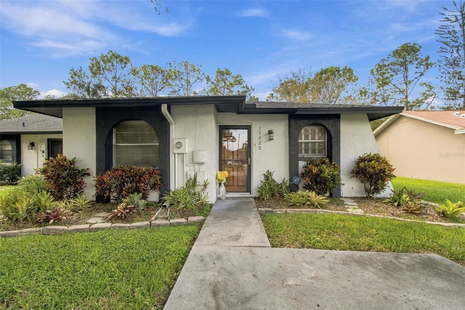 Your well maintained home features a weather glass door and a solid wood front door.