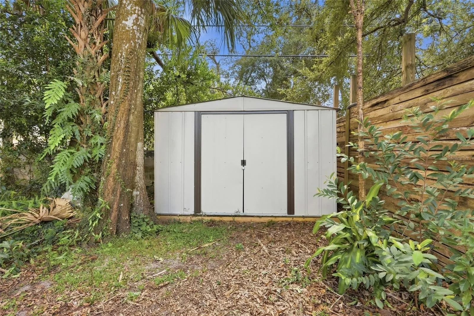 A backyard storage shed keeps garden tools and weekend projects nearby.