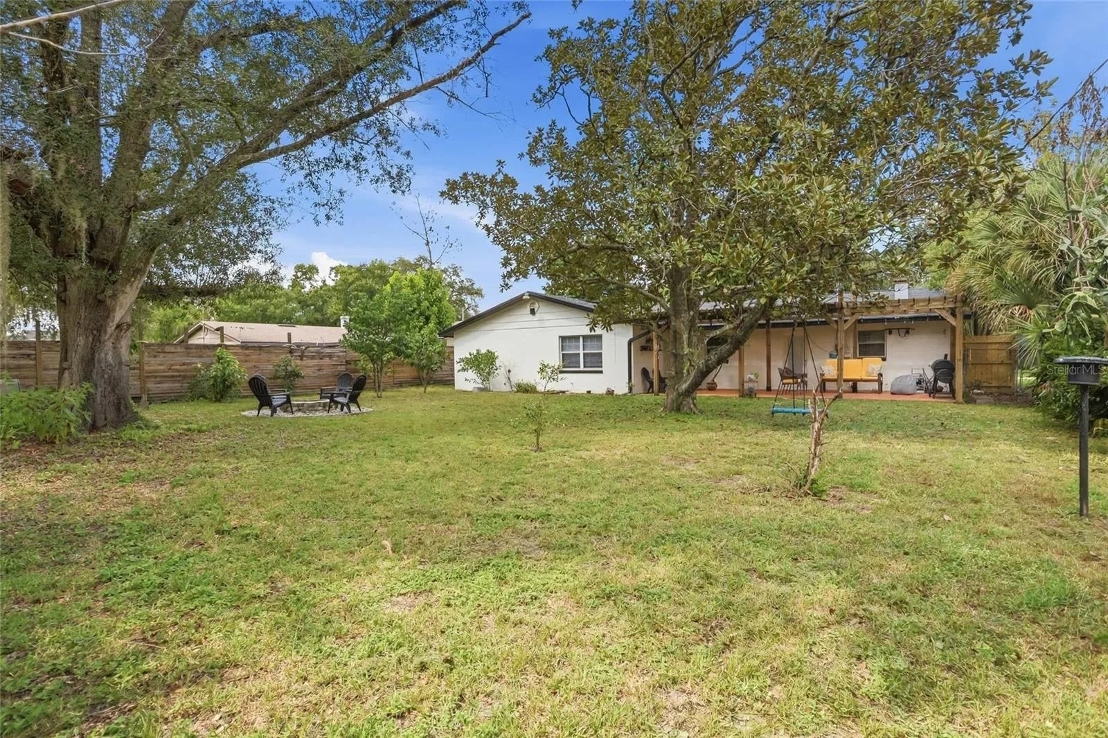 Mature trees and open lawn invite more time in the backyard.
