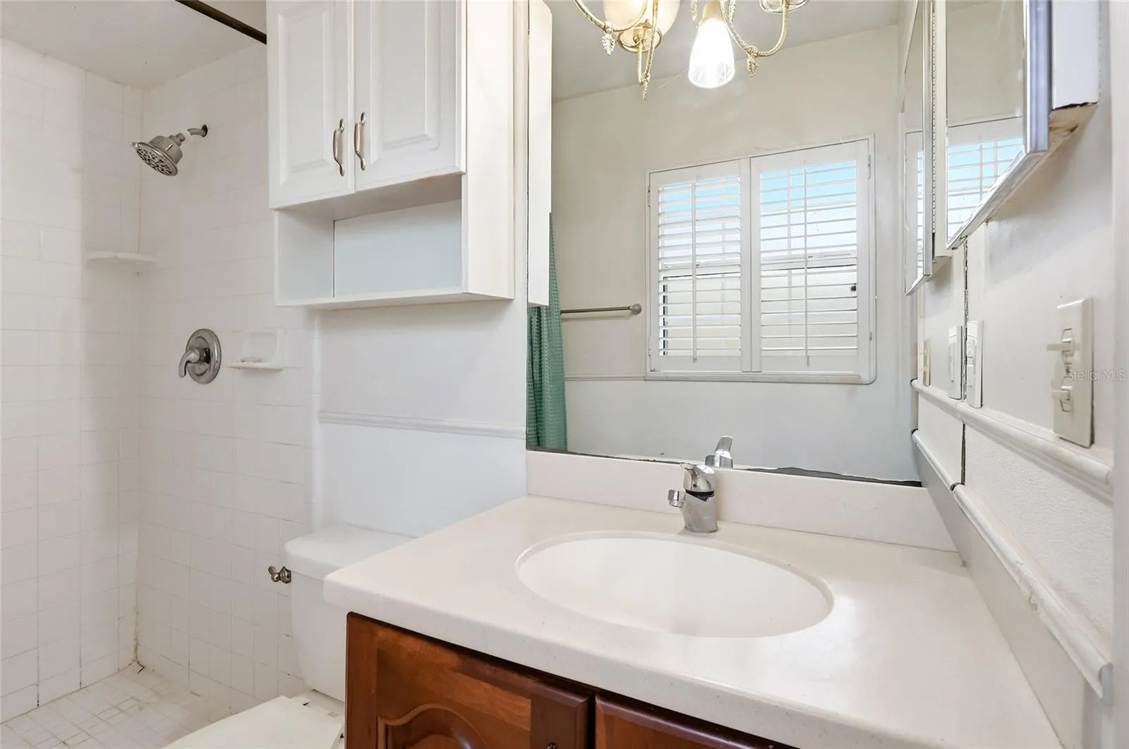Primary bathroom vanity and wall-mounted storage keep daily essentials close.