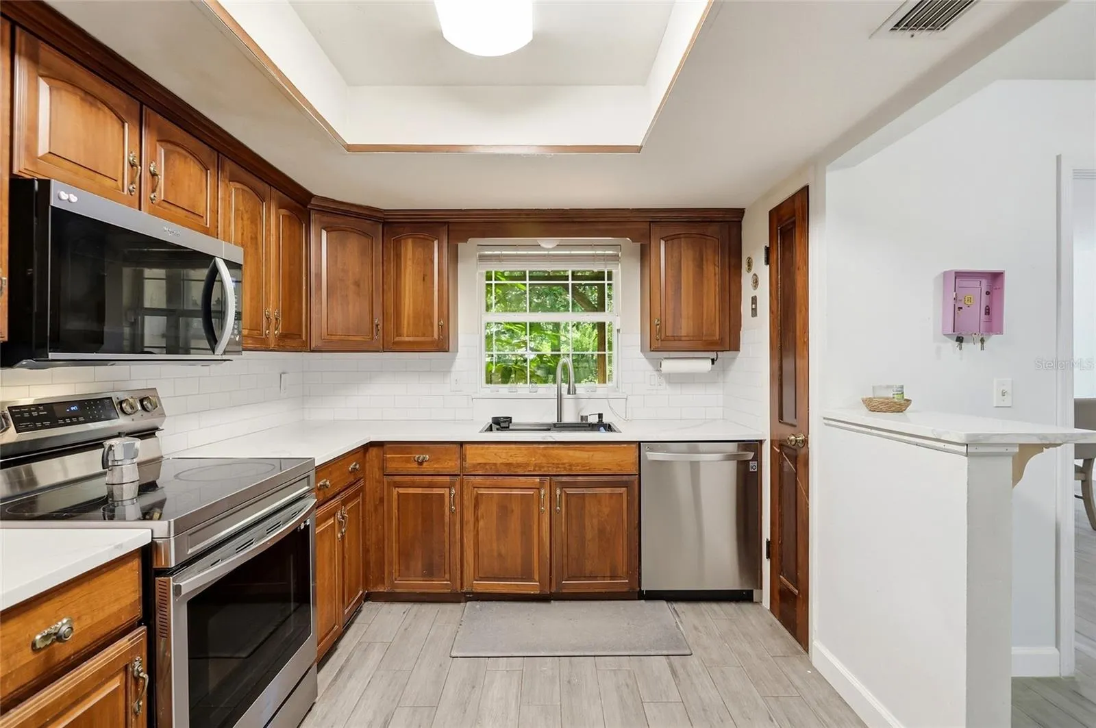 A window above the kitchen sink brings daylight to daily routines.
