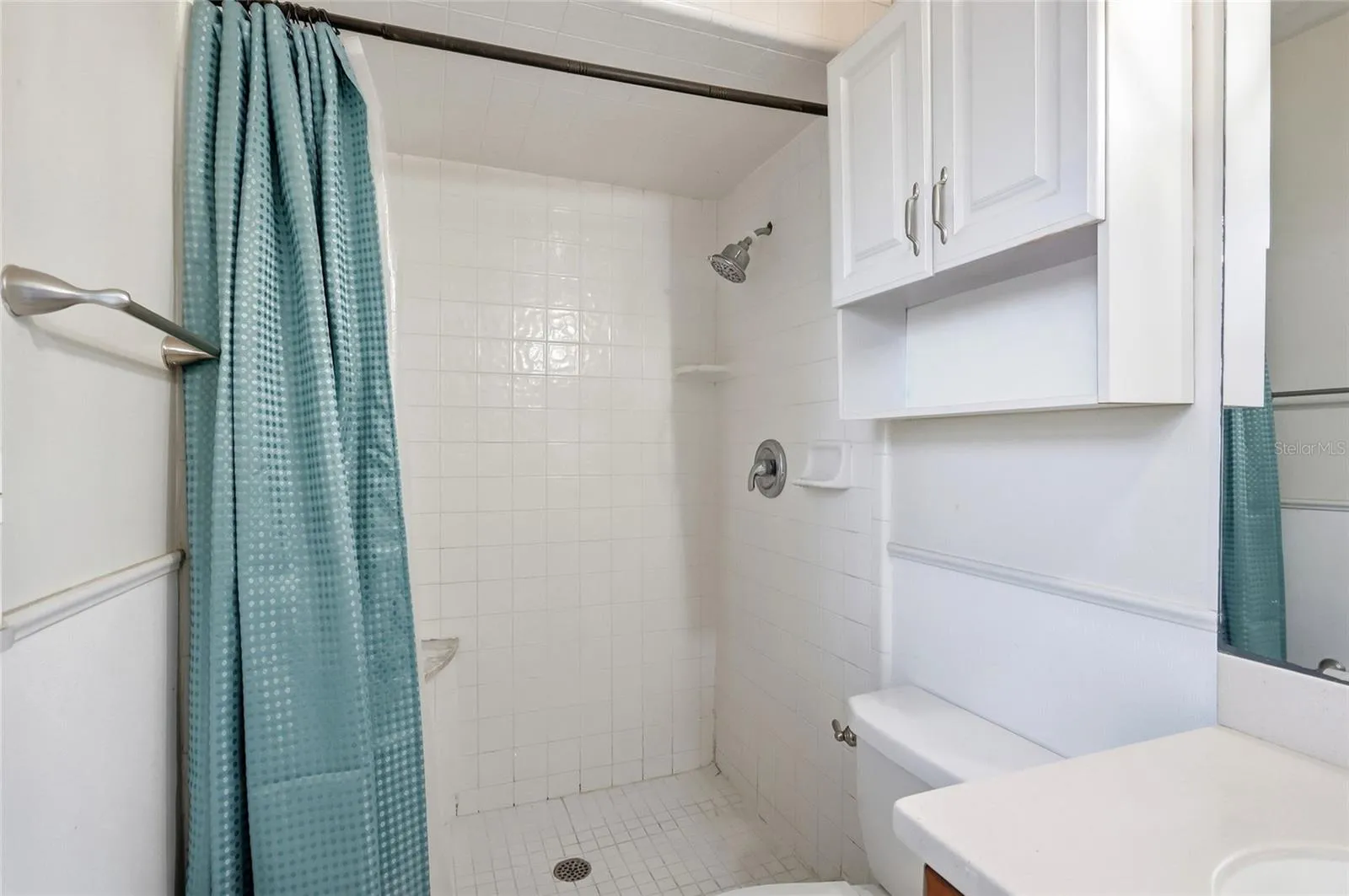 A tub and shower combination offers space to refresh or unwind.