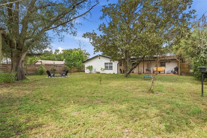 Mature trees and open lawn invite more time in the backyard.