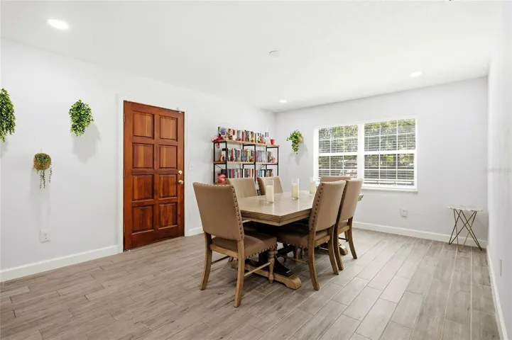 Gather around the table in a dining area filled with natural light.