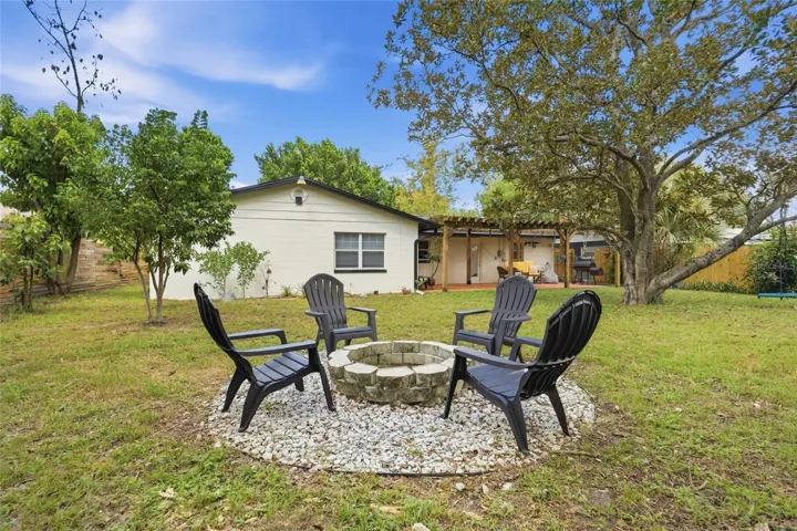 Backyard evenings begin around the fire-pit seating area.
