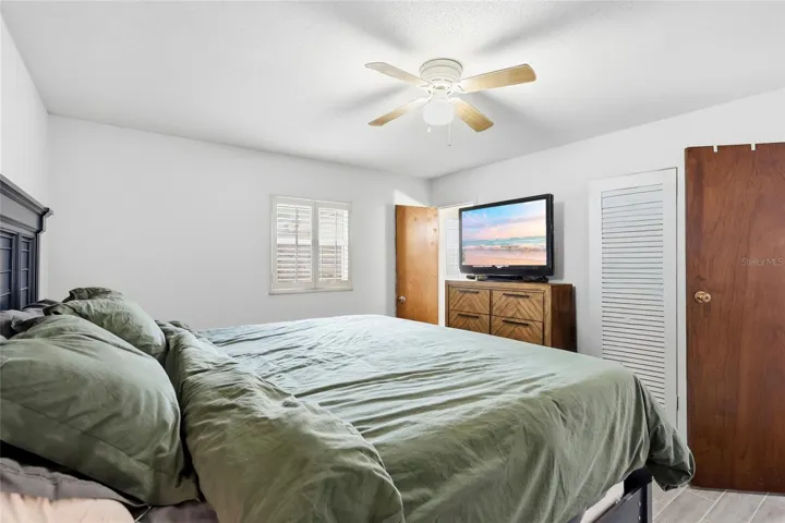 Another view of the primary bedroom highlights its layout and closet access.
