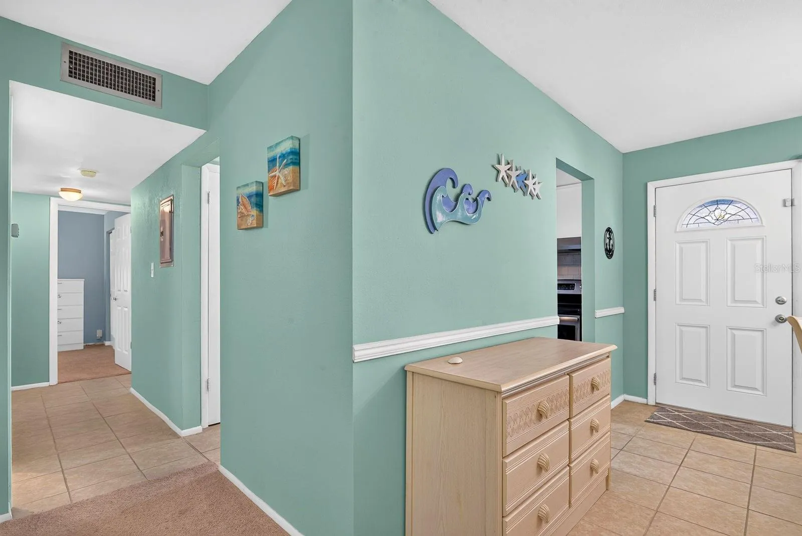 Entry featuring coastal neutral colors and space