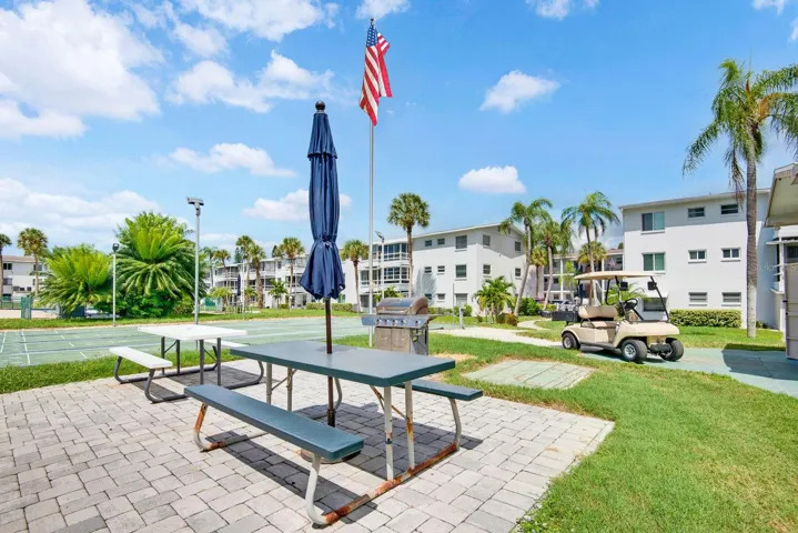 Beautiful Common area for gathering including picnic tables and shuffleboard