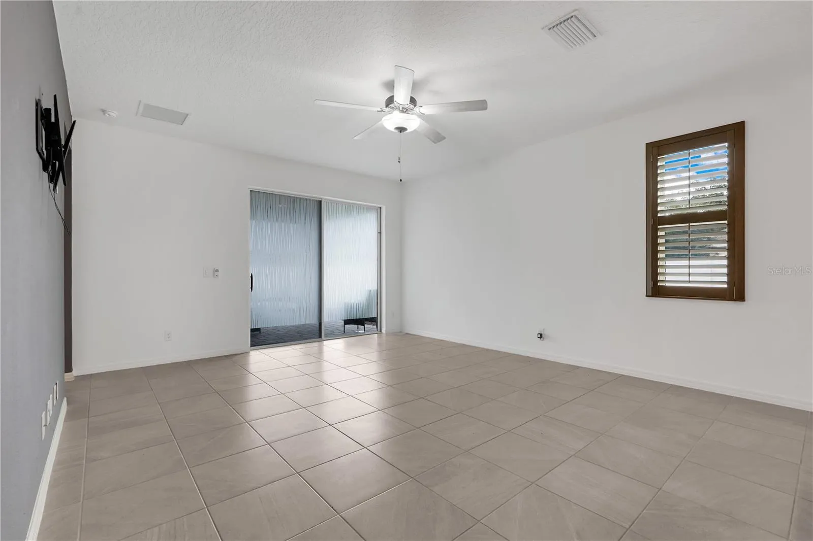 Family room with a sliding door leading to the lanai.