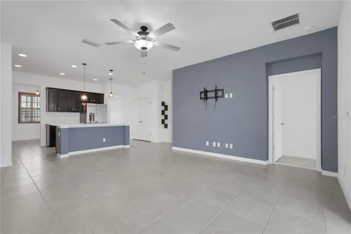 Family room with the kitchen and the entrance to the primary bedroom.
