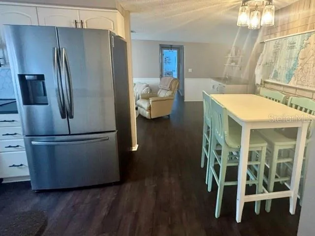 View from dining room into kitchen, bonus room and hall to 2nd bedroom/bathroom