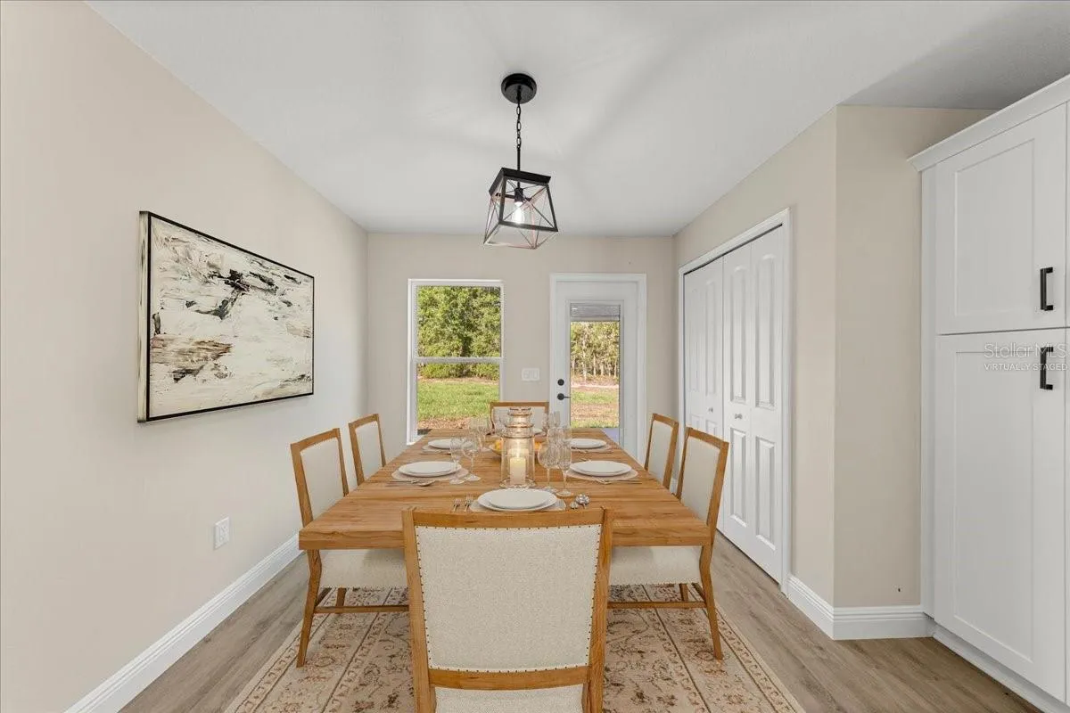 Virtually Staged. Kitchen Eating area with drop down lighting