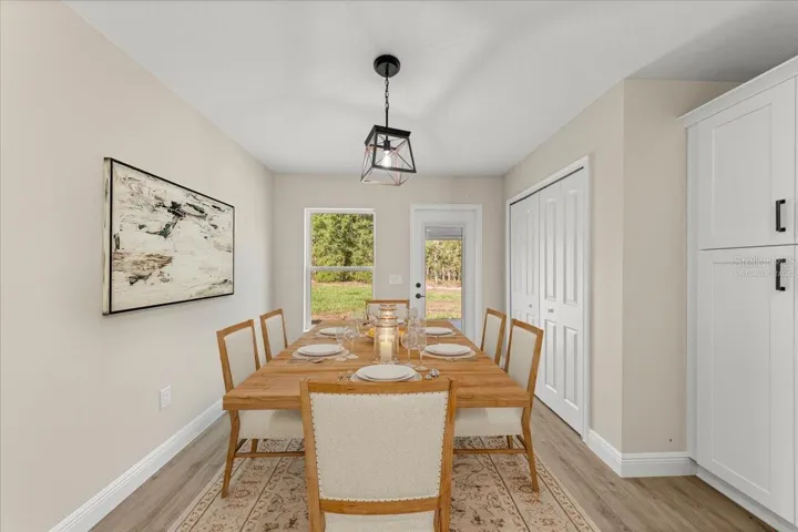 Virtually Staged. Kitchen Eating area with drop down lighting