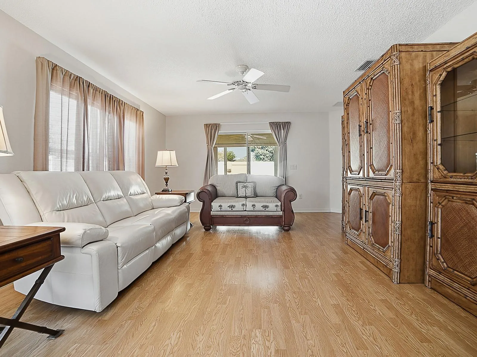 View of living room to sliders to lanai