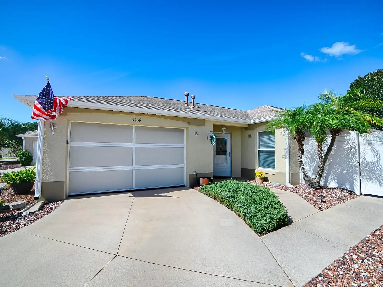 Welcome to 484 Aintree Lane. Beautiful Screened garage door and low maintenance landscaping