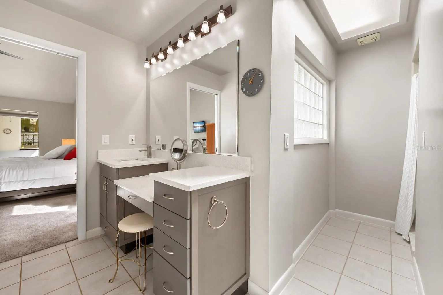 Primary bathroom features dual vanities, shower and tub