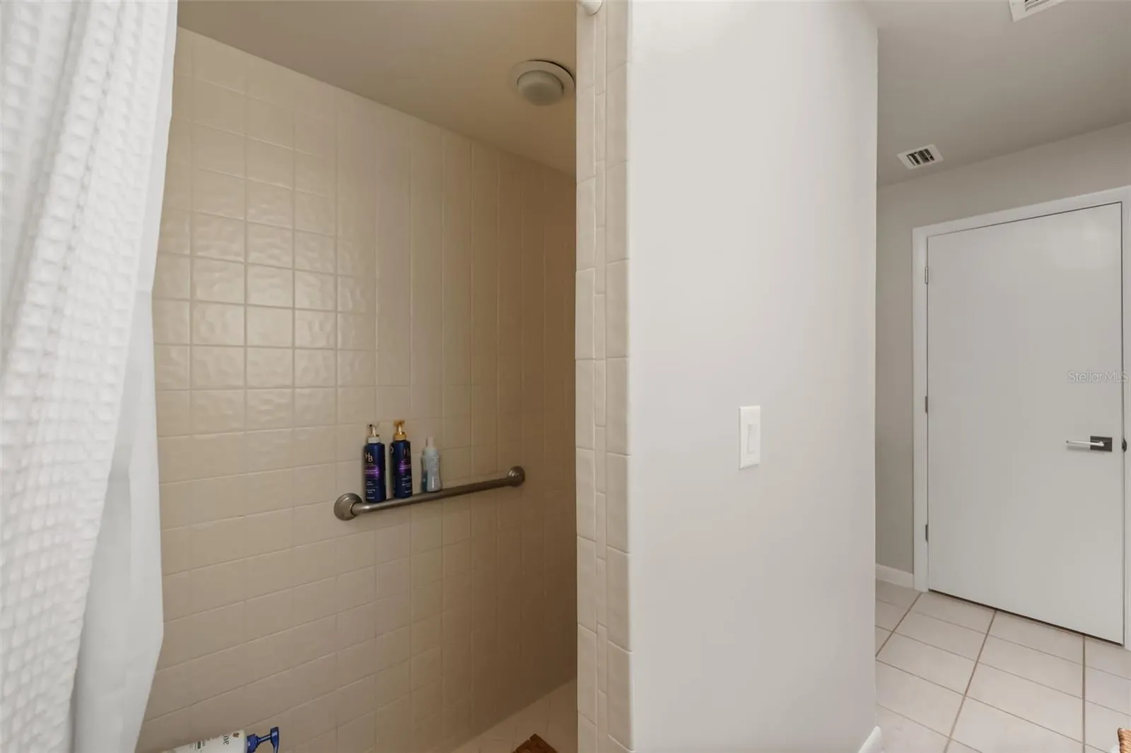 Primary bathroom features dual vanities, shower and tub