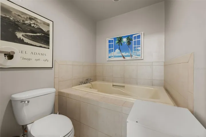 Primary bathroom features dual vanities, shower and tub