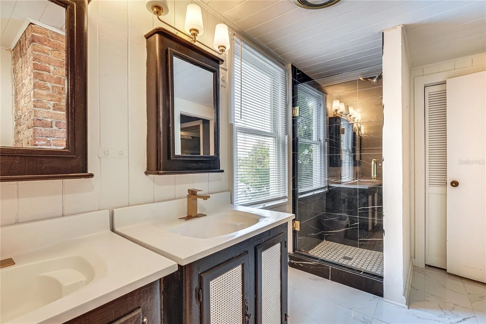 Updated Bathroom with Double Vanity and Exposed Brick