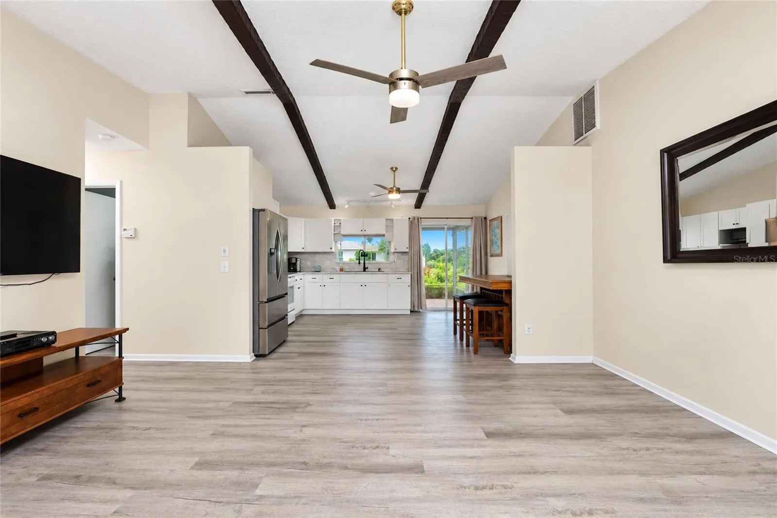 View as you enter the front door looking through the living room, dinette and kitchen to the lanai.